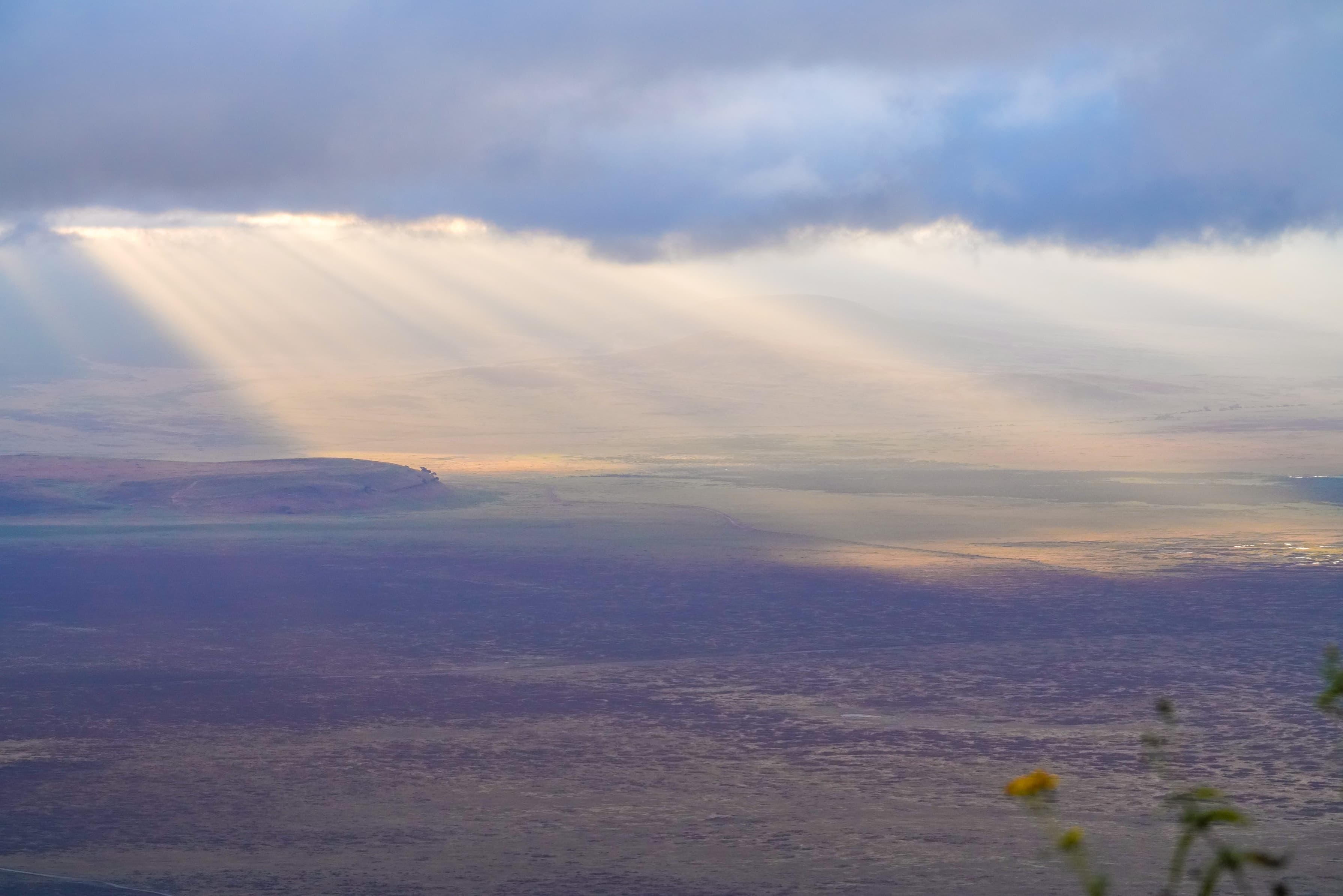 Shafts of light falling across the floor of the Ngorongoro Crater, Tanzania